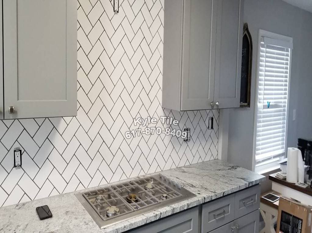 picture of a newly remodeled kitchen with diagonal tile wall backsplash