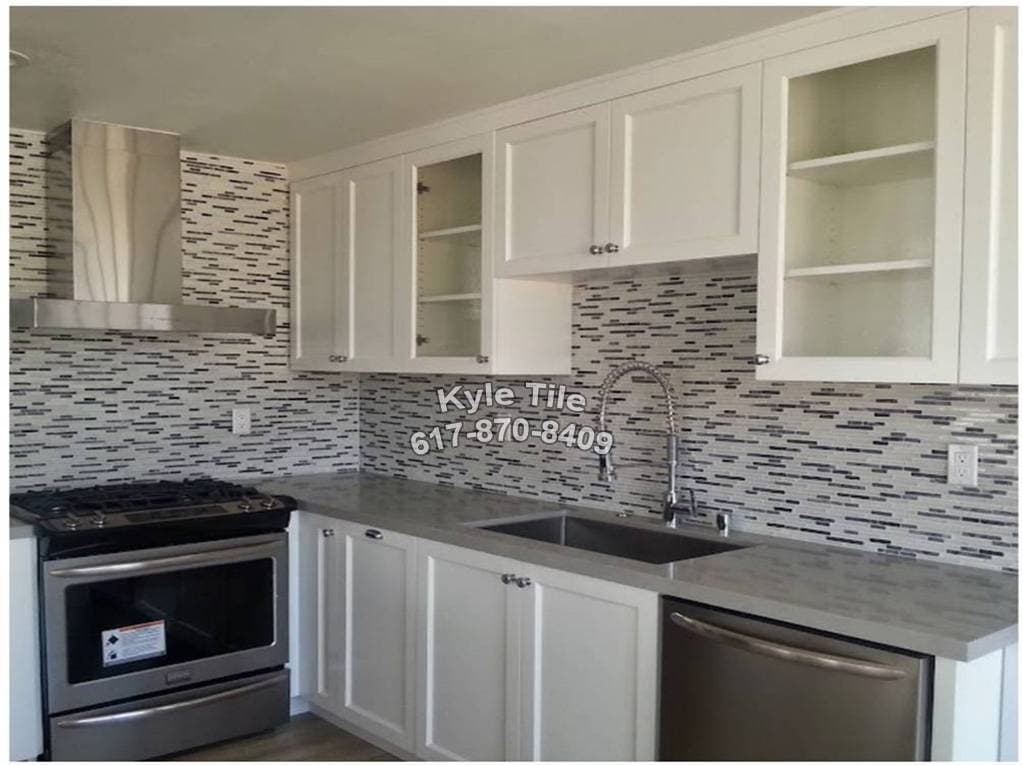 picture of a luxury kitchen tile backsplash with various gray white and blue tiles