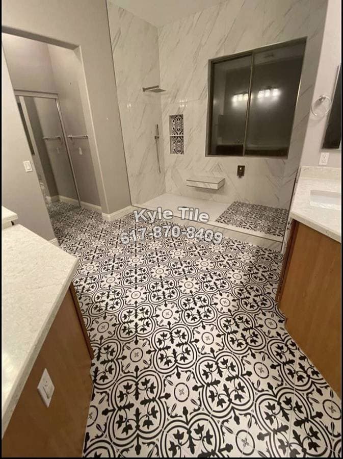 picture of a freshly custom tiled black and white floor and newly tiled bathroom shower walls