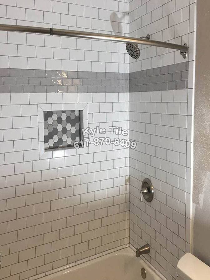 picture of a freshly tiled bathroom with white tiles