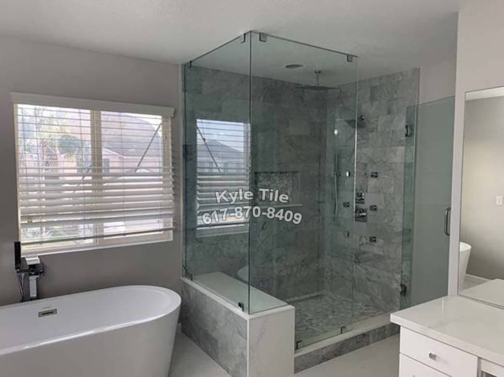 picture of a remodeled luxury bathroom with gray texture tiled floor and walls  